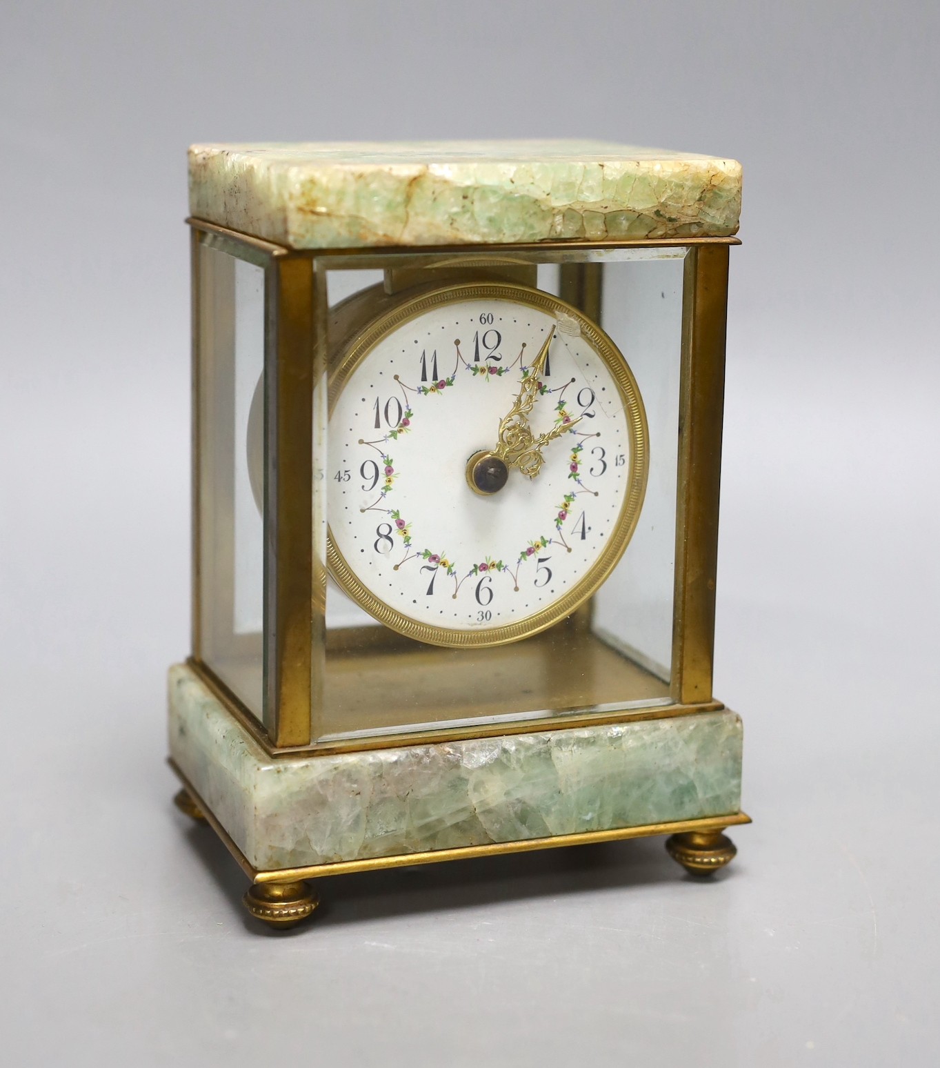 A French onyx and brass small mantel clock, with ornate enamel dial,14.5cms high